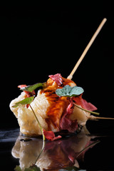 Food in batter on a black background with flowers
