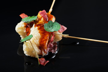 Food in batter on a black background with flowers