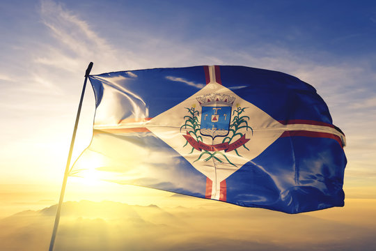 Patos de Minas of Brazil flag waving on the top sunrise mist fog