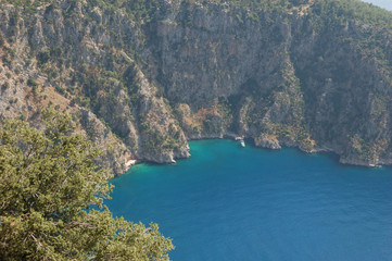 Fototapeta premium The unbelievably blue sea waters of the Butterfly Valley (Kelebekler Vadisi) in Turkey