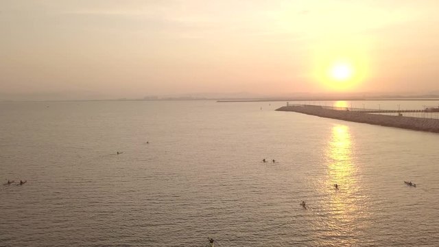 Long, narrow and fast racing sea kayaks. Early morning on a background of amazing sunrise.