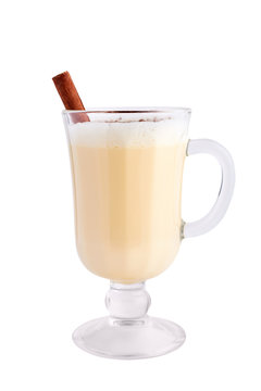 Homemade eggnog with cinnamon isolated on white background. Typical Christmas dessert.