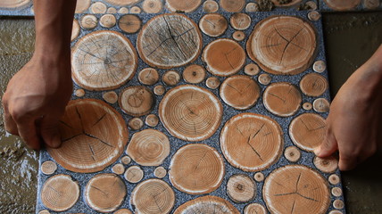 Documentation of construction workers when installing ceramic tiles for floors, selectively focusing and bluring objects and not focusing