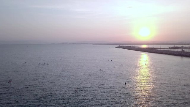 Long, narrow and fast racing sea kayaks. Early morning on a background of amazing sunrise.