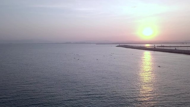 Long, narrow and fast racing sea kayaks. Early morning on a background of amazing sunrise.