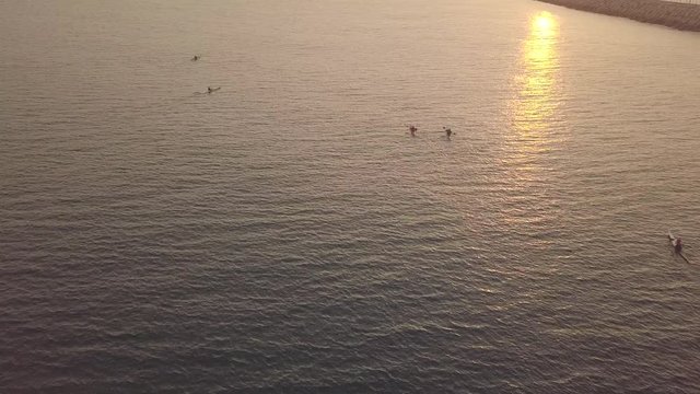 Long, narrow and fast racing sea kayaks. Early morning on a background of amazing sunrise.