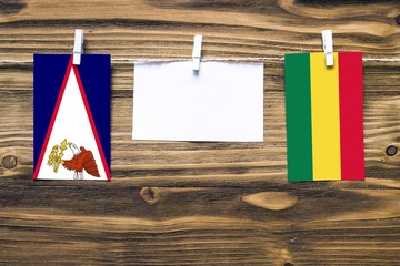 Hanging flags of American Samoa and Bolivia attached to rope with clothes pins with copy space on...