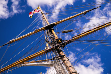 Mast, rigging and flags of a classic sailing ship.