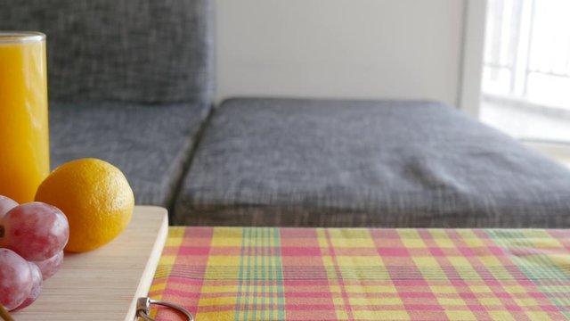 cinematic 4K Travelling of fruits and juices platter on madras pattern tablecloth. beautiful shot of morning healthy breakfast