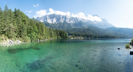 View of Eibsee lake in Bavaria, Germany with Mountain in the background and a hotel at the lake shore