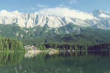 View of Eibsee lake in Bavaria, Germany with Mountain in the background and a hotel at the lake shore
