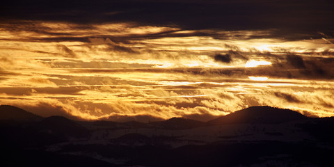 Apuseni mountains at sunset in golden light and in silhouette