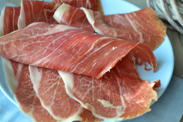 Raw fresh marbled meat on blue plate close up