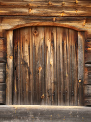 Old and rustic hatch on a log hut