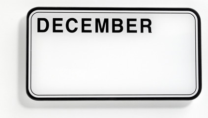 A picture of a car plate with the December calendar month