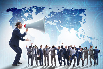 Businessman shouting through large loudspeaker