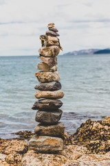 Fototapeta na wymiar pebbles and rocks in relaxing zen inspiring stack on the beach in Australia