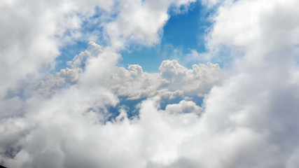 Flying through picturesque sunny cloudscape. Amazing of soft golden clouds moving in pure sunshine...