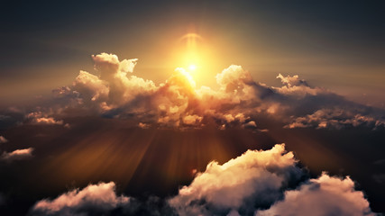 Flying through picturesque sunny cloudscape. Amazing of soft golden clouds moving in pure sunshine and the sun glowing through the clouds with beautiful rays and lens flare.