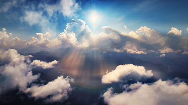 Flying through heavenly beautiful sunny cloudscape. Amazing of golden fluffy clouds moving softly on the sky and the sun shining through the clouds with beautiful rays and lens flare.