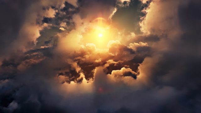 Flying through picturesque sunny cloudscape. Amazing of soft golden clouds moving in pure sunshine and the sun glowing through the clouds with beautiful rays and lens flare.