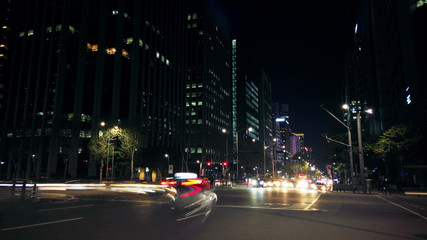 Fototapeta na wymiar Beautiful night of Seoul road traffic, view on the busy intersection in Gangnam District. Cars, buses and other vehicles passing by creating picturesque light trails.