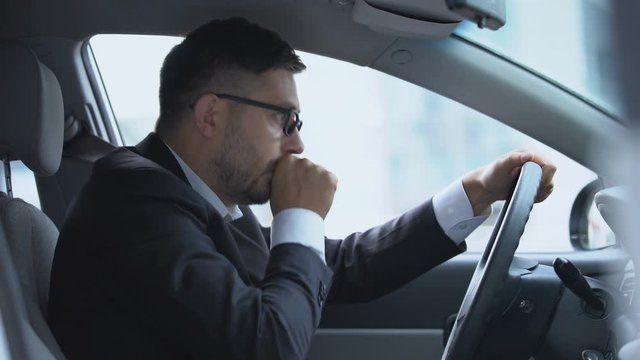 Male driver stopping his car because of cough attack, risk of pneumonia, asthma