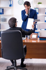 Boss and his male assistant working in the office