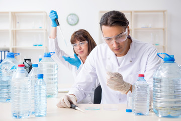Two chemists working in the lab