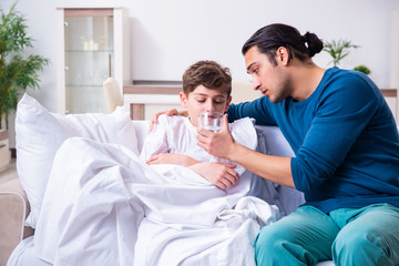 Young father caring for sick son