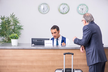 Old businessman at the hotel reception