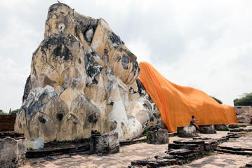 an ancient statue of the Buddha in the ruins on Ayutthaya, Thailand