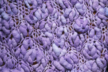 Fototapeta na wymiar Lilac textured Knitted background. Close up of wool fabric texture.