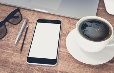 Smartphone with blank screen and laptop on wood office desk, 3d rendering