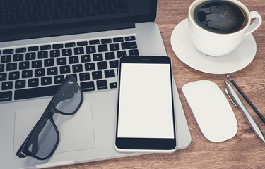 Smartphone with blank screen and laptop on wood office desk, 3d rendering