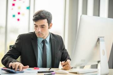 Businessman working in office with desktop computer and documents on his desk with copy space using as background professional business people, successful business man consultant concept.