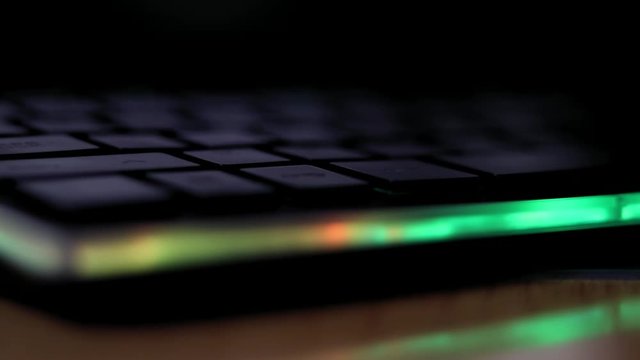 Glowing in the dark , black keyboard with animated keys with rainbow, colorful illumination, glowing in the dark. Pc master race gaming gear