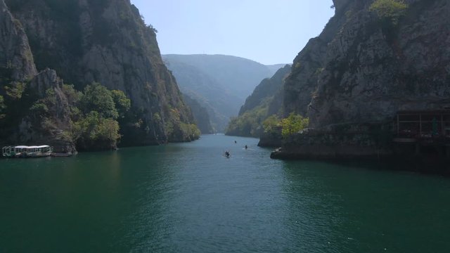 Aerial footage of people canoeing in Matka canyon in Macedonia on a sunny day