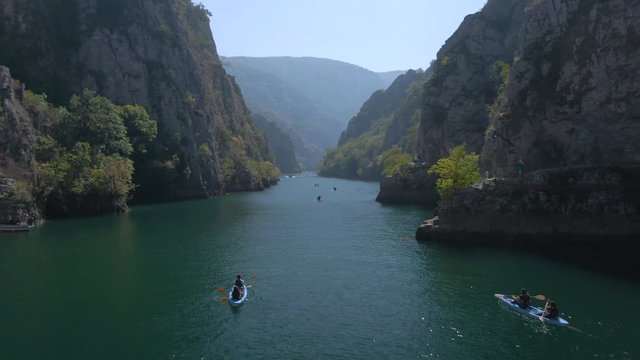 Aerial footage of people canoeing in Matka canyon in Macedonia on a sunny day