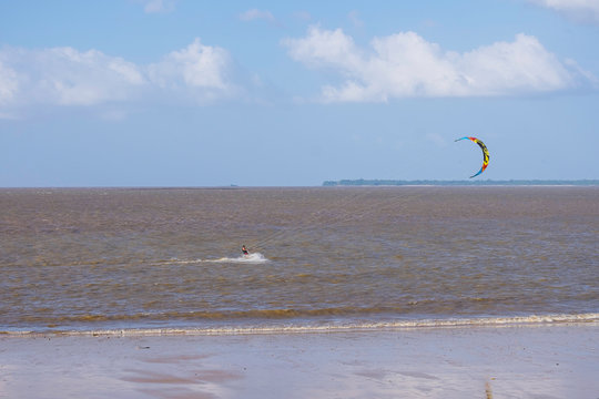 beach with blue sky with parapent flight.