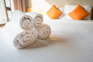 Set of towel on the bed in hotel bedroom. Conceptual of hotel amenities. - obrazy, fototapety, plakaty