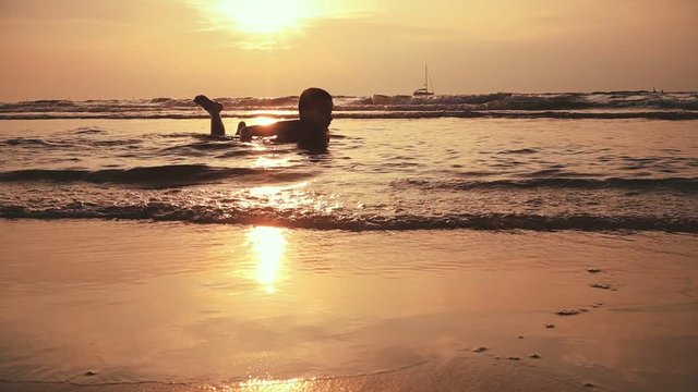 Lonely Boy Ten-year-old Throwing Skipping Stone In Sea Golden Sunset. Tourism Concept, Sea Vacation