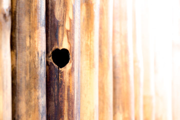 The heart-shaped on wood panel texture of wall room at sunset time, Natural material design for interior and exterior, Brown wood texture and background.Symbol a representative of love.(love is wonder