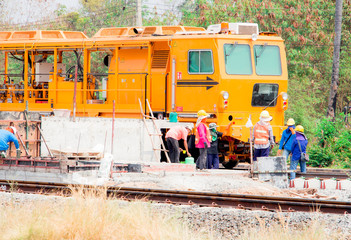 Rail repair With machines and workers. Machine repairing railway, workers were building a railway,...