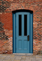 Fototapeta na wymiar Blue door and brick walls in the old town 