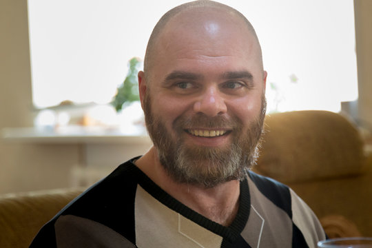 Portrait of a bald man with a beard