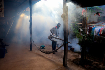 A man use fumigation mosquitoes machine for kill mosquito carrier of Zika virus and dengue fever prevention outbreak in school at the rainy season.Soft and blur focus.