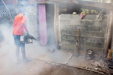 A man use fumigation mosquitoes machine for kill mosquito carrier of Zika virus and dengue fever prevention outbreak in school at the rainy season.Soft and blur focus.