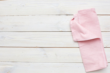 top view of pink napkin on a white wooden table