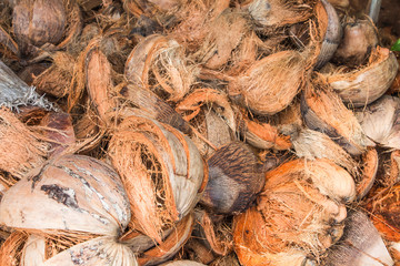 Brown coconut peel place stacked together.